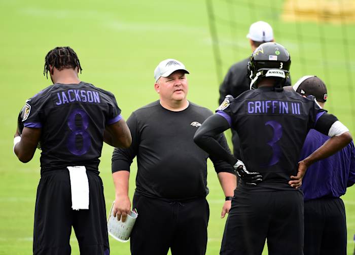 Baltimore Ravens offensive coordinator Greg Roman (center) talks to quarterbacks Lamar Jackson (8) and Robert Griffin III (3) during minicamp at Under Armour Performance Center.
